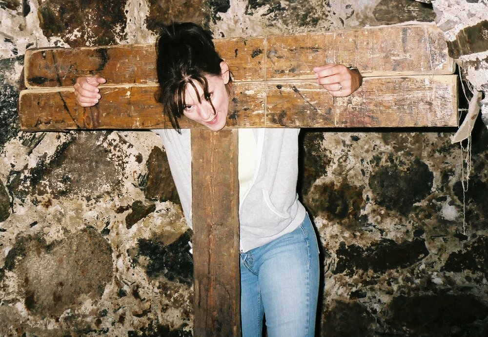 young wife in a stone basement pillory