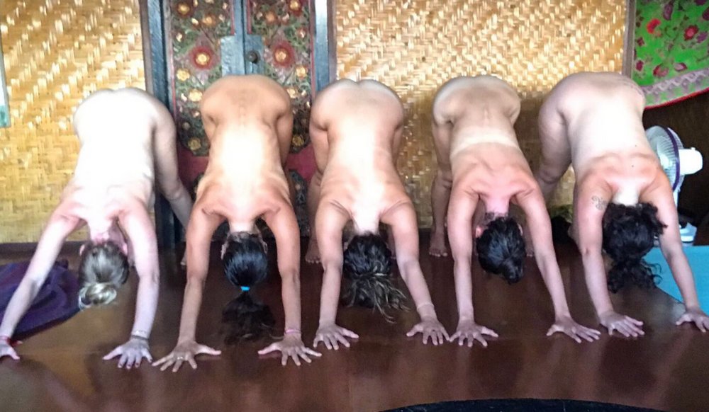 nude women doing naked downward dog positions