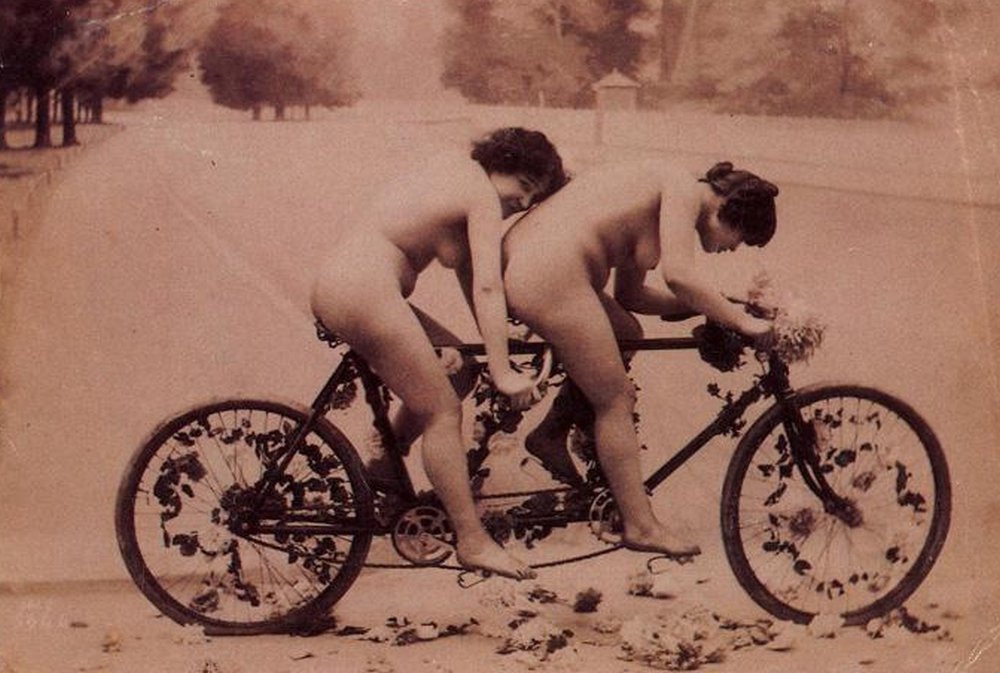 naked lesbians on a tandem bicycle covered in flowers