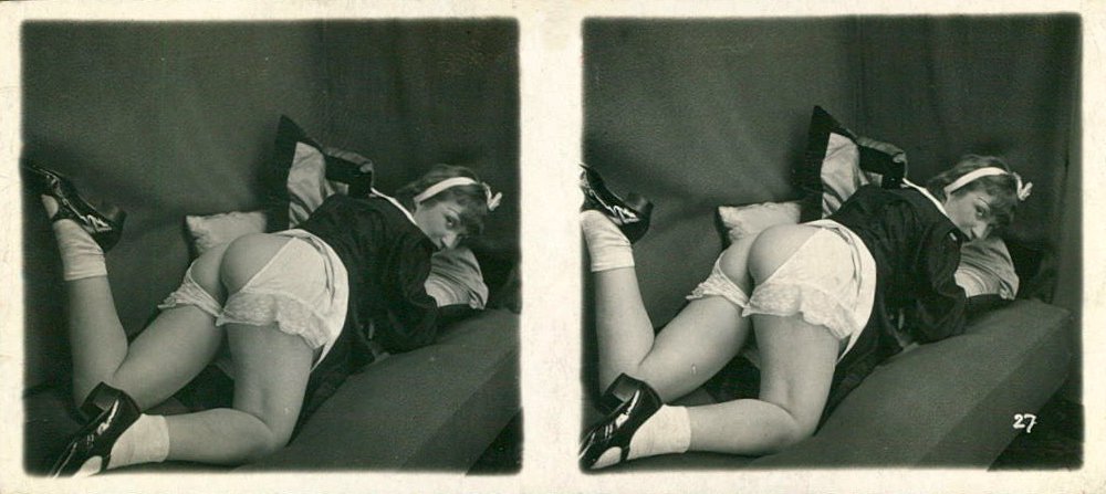 a vintage stereo view card of a woman reclining with her bottom exposed through split knickers